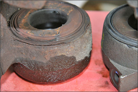 Rust and pieces of dust boot (left caliper in the photo) in the piston bores or the hairline cracks and scoring on the caliper pistons' surfaces